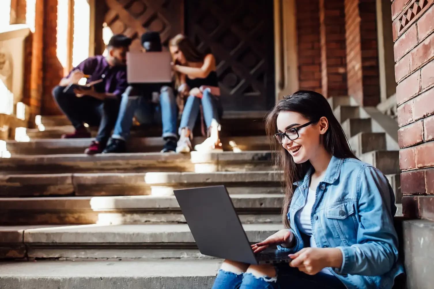 Student working on laptop outdoors